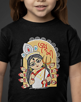 Child wearing a black t-shirt with a colorful graphic design on a dark background